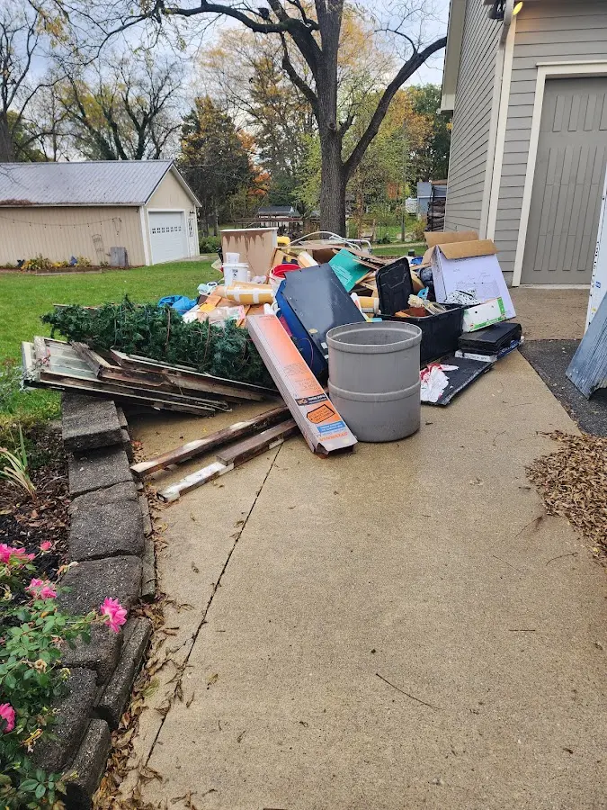 Dumpster being loaded with debris for Estate Cleanout Dumpster Rental in Port Chester